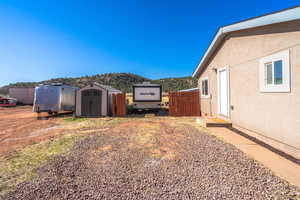 View of yard featuring a storage unit and a mountain view