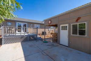 View of patio with french doors, a deck, and cooling unit