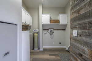 Washroom with dark wood-type flooring and wooden walls