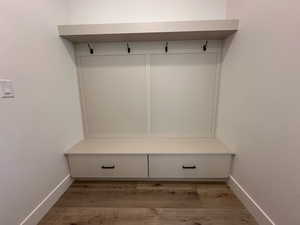 Mudroom with baseboards and wood finished floors