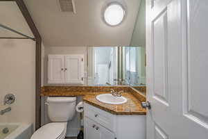 Full bathroom with vanity, shower / washtub combination, and toilet