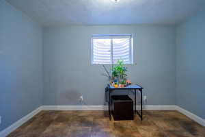 Unfurnished room with a textured ceiling