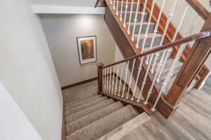 Stairway featuring wood-type flooring