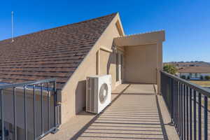 Exterior space with a balcony and ac unit