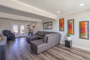 Living room featuring hardwood / wood-style floors, crown molding, and french doors