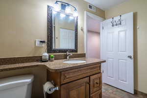 Bathroom featuring vanity and toilet