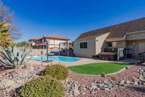 View of pool featuring a hot tub and a patio area