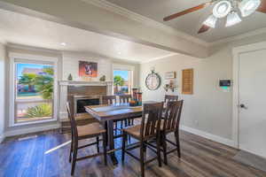 Dining area featuring ornamental molding, dark hardwood / wood-style floors, and a textured ceiling