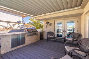 Deck featuring area for grilling, grilling area, and french doors