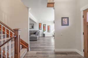 Hallway with hardwood / wood-style flooring and ornamental molding