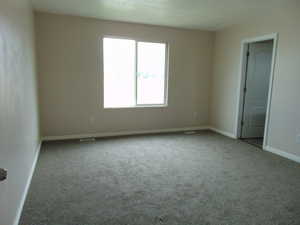 Unfurnished room featuring light colored carpet