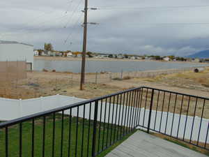 Wooden terrace featuring a lawn and a water view