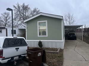 View of side of home with a carport