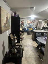 Office area with a textured ceiling and light tile patterned floors