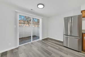 Unfurnished dining area with light hardwood / wood-style flooring