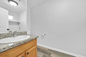 Bathroom featuring vanity and hardwood / wood-style floors