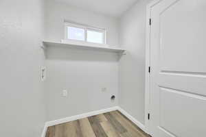 Washroom featuring hookup for a washing machine, hardwood / wood-style floors, and electric dryer hookup