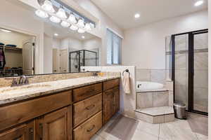 Bathroom with tile patterned flooring, plus walk in shower, and vanity