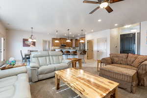 Living room featuring ceiling fan and light colored carpet