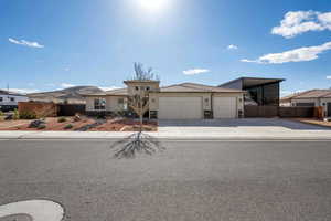 View of front of property featuring a carport, a garage, and a mountain view