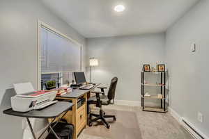 Office area with baseboard heating and light colored carpet