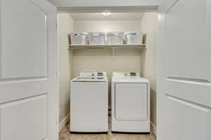 Clothes washing area featuring washer and clothes dryer