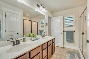 Master bathroom with walk in shower and dual vanity