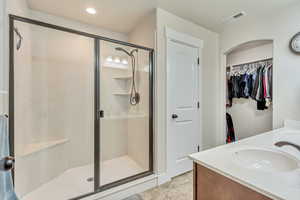 Master bathroom with dual vanity and a shower with shower door