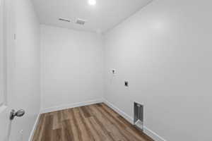 Clothes washing area featuring hookup for a washing machine, hardwood / wood-style floors, and electric dryer hookup