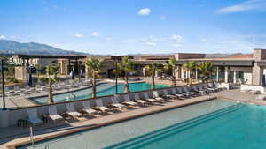 View of swimming pool with a mountain view and a patio area