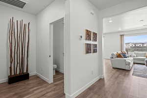 Hall featuring dark hardwood / wood-style flooring and a textured ceiling