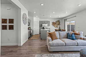 Living room with hardwood / wood-style floors and a textured ceiling