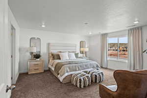 Carpeted bedroom with a textured ceiling