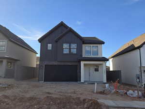 View of front of property featuring a garage