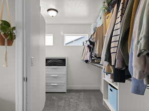 Walk in closet with dark carpet