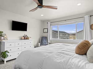 Bedroom featuring light colored carpet and ceiling fan