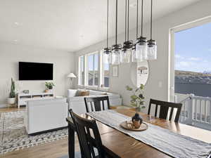 Dining area with a water view and light wood-type flooring