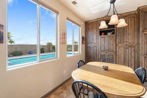 Dining space with light tile patterned floors