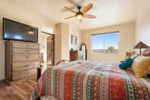 Bedroom with ceiling fan and hardwood / wood-style floors