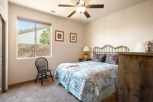 Carpeted bedroom with ceiling fan