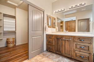 Bathroom featuring vanity and wood-type flooring