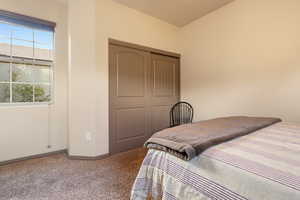 Bedroom with carpet floors and a closet