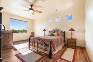 Bedroom with dark wood-type flooring and ceiling fan