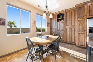 Dining space featuring a notable chandelier