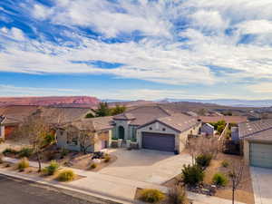 View of front of house with a garage and a mountain view