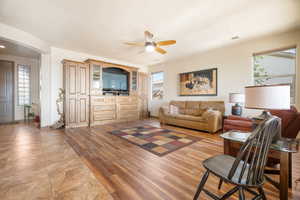 Living room with light hardwood / wood-style flooring and ceiling fan