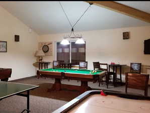 Recreation room with lofted ceiling, pool table, and carpet