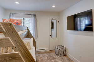 Interior space featuring light hardwood / wood-style flooring and a baseboard radiator