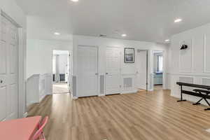 Interior space featuring a textured ceiling and light hardwood / wood-style floors