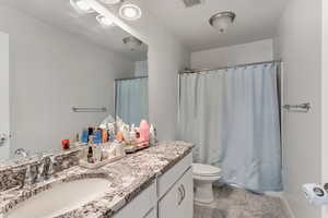 Bathroom with tile patterned flooring, vanity, and toilet